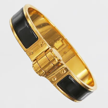 Armband Hermés "Charnière Hinged Bracelet", guldfärgad metall, svart dekor, SP 0136, innermått 58x45mm, slitage, repor, inga tillbehör. 