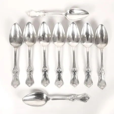 Nio matskedar, modell Olga, J. B. Holm, år 1855, längd: 213 mm, gravyr, silver. Vikt: 560 g