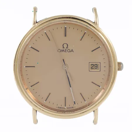 Herrur Omega i 18K guld utan band. Boett Ø 32,5 mm. Safirgas. Datum. Quartz - Går ej - batteribyte krävs? Graverad boett. 