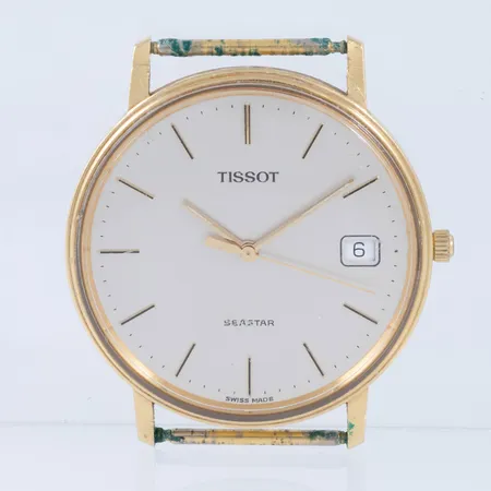 Herrur Tissot Seastar i 18K guld utan band. Boett Ø 33,5 mm. Datum. Quartz - Går ej - batteribyte krävs? Repigt plastglas. Gravyr på boett. 