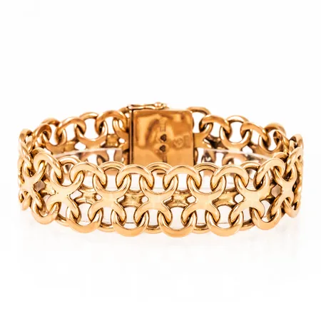 Armband X-länk i 18K guld. Det är 19,2 mm brett, 20,5 cm långt och väger 96,2g. Kistlås. Stämplad MKS (M.K:s Guldsmedsatelje), H9 (1958), 18K & Kattfot.