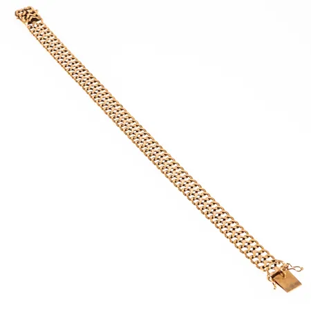 Armband, fiskbenslänk i 18K guld. Det är 10 mm brett, 21,5 cm långt och väger 16,6g. Kistlås. Stämplad STAB (Styletta Guldvaruaktiebolaget, Stockholm), T9 (1969), 18K & Kattfot.