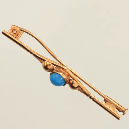 Brosch med blå sten, längd 44mm, bredd 7mm, skev nål, 18K  Vikt: 2,3 g