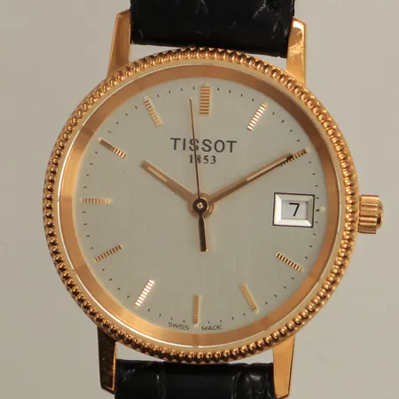 Damur Tissot, boett i 18K, 24mm, quartz, datum, läderarmband, längd inklusive ur ca 19cm, gravyr, originalask, bruttovikt: 16,8g