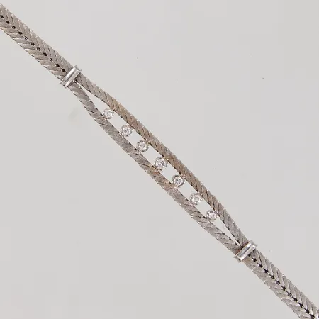 Armband, 18cm, bredd 4,8-8mm, diamanter 1x ca 0,06ct, 4x ca 0,04ct, 2x ca 0,03ct, höjd stenar 5mm, vitguld, 18K Vikt: 20,4 g