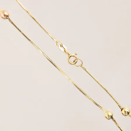 Vristlänk med integrerade kulor, längd: 25cm, bredd: 0,9-4,1mm, skev, 18K  Vikt: 3 g