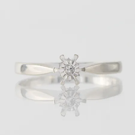 Ring med diamant ca 0,03ct, stl 18¾mm, bredd skena 1,95mm, 18k vitguld Vikt: 2,4 g