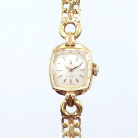 Damur Omega mekanisk, helguld boett 15x25mm, längd 18cm, bredd 6mm, armband X-länk    Vikt: 21,5 g