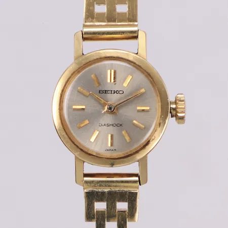Damur, Seiko Diashock, Ø17,2mm, 820420, manuell, buckla, repor på plastglas 14K, urarmband 18K. Bruttovikt 23,9g,