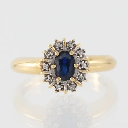 Carmoséring med diamanter totalt 0,05ct samt safir, Guldfynd AB, storlek 17 mm, bredd 2.2-10.8 mm, 18k. Vikt: 3,6 g