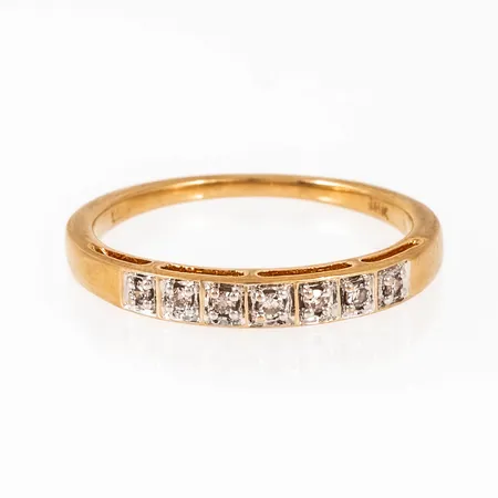 Ring i 18K guld med 7 x c:a 0,01ct åttkantslipade diamanter fattade i carréfattning. Den är 1,3 - 2,9 mm bred, är i storlek 18 och väger 2,8g. GHA, 18K.