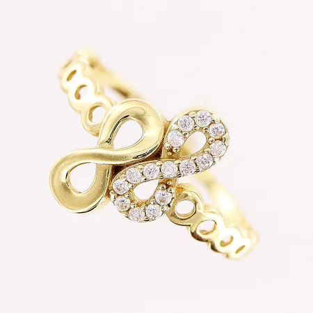 Ring, evighetstecken, vita stenar, stl 16¾, bredd 1-12,5mm, 14K Vikt: 1,6 g