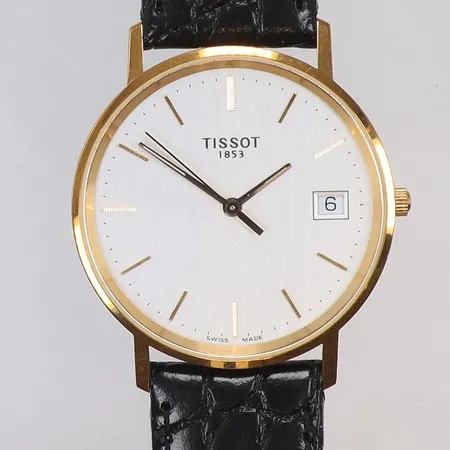 Herrur Tissot 18K Ø33,5mm, ref nr H674.330, quartz (går ej, troligen batteribyte), läderband (nyskick), gravyr "För Nit och Redlighet", guld i boett, med box och manual, bruttovikt 30,2g