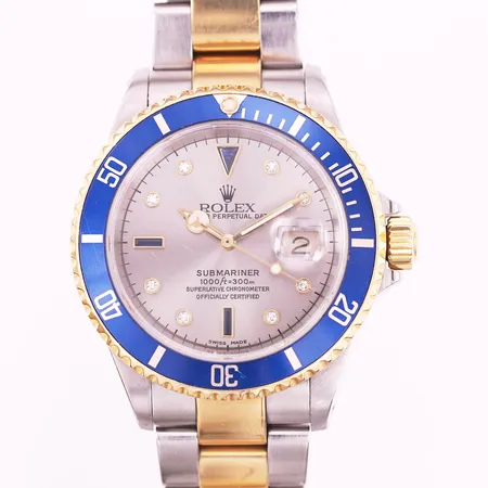 Herrur Rolex Oyster Perpetual Submariner, guld/stål, automatisk, ref-nr16613, serie-nr K245172, Serti Dial, Ø40mm, diamantindex samt safirer, boett-nr 2160, kaliber 2160, verk-nr 3 9207347, 13 länkbitar monterade, clasp 93253 DT1, manual, plånbok, sigill, ankare och certifikat Nymans Ur Stockholm 2002, små repor.