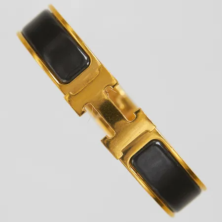 Armband, Hermès Clic Clac H, gulmetall med svart emalj, ca 55x45mm, märkt Hermès Made in France, bredd: 11,5mm, ytliga repor, inga tillbehör