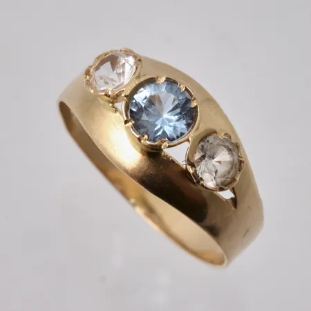 Ring i 18K guld, stl 17, bredd 3,7-8,6mm, 1 blå sten, mått Ø4mm, 2st vita stenar, mått Ø3,6mm, tillverkad av Dahlströms Guldsmedsaffär Eftr, år 1962, vikt 1,9g.