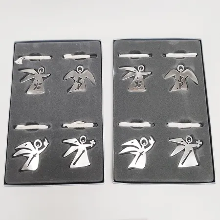 8 Juldekorationer, änglar, Georg Jensen, rostfritt stål, höjd ca. 4,5cm, två paket i orginalförpackningar varav ena med fläck. 