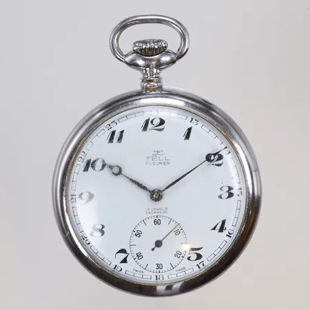 Fickur Tell Fleurier Ø50mm, manuell uppdragning, boett i kromad gulmetall, repigt plastglas, omkring 1900-talets mitt 