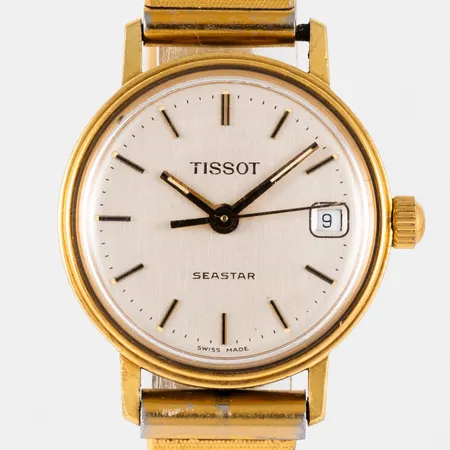 Damur Tissot Seastar i 18K guld, band i metall, längd 18,5 cm. Boett Ø 22 mm med gravyr "För nit...", datum, quartz, repigt plexiglas. Går ej, batteribyte krävs?  Vikt: 0 g