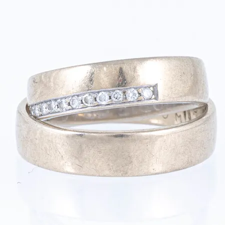Graverat guld i 18K vitguld. Vikt: 11,1g.