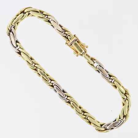 Armband, längd 19,5cm, bredd 5,4mm, ihålig, tvåfärgad 14K.  Vikt: 13,1 g