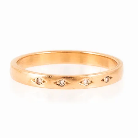 Ring i 18K guld med 4 x 0,005ct åttkantslipade diamanter. Den är i storlek 17½, är 2,5 mm bred och väger 2,4g. Stämplad Q10 (1990), WAD (HB Wadring-Juvel, Karlskrona), 18K & kattfot. Stenstorlek graverad 0,02ct.