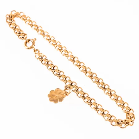 Armband X-länk i 18K guld med berlock fyrklöver. Det är 19 cm långt,  4,2 mm brett och väger 5,2g. Stämplad RHG, 18K & kattfot. Springring. 