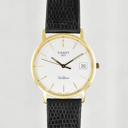 Herrur Tissot Goldrun 18K, boett Ø34 mm, quartz, datum, defekt läderband, graverad bakboett, behov av batteribyte, bruttovikt 28,6g. 