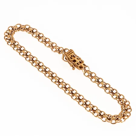 X-länksarmband i 18K guld. Det är 19 cm långt, 5,4 mm brett och väger 6,5g. Kistlås. 