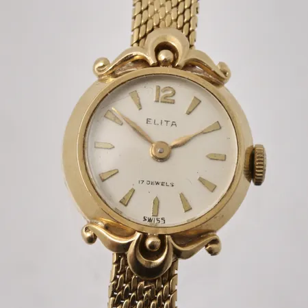 Damur Elit i 18K guld, 17,5cm, bredd 6,4-20mm, 17 jewels, boett-nr 4765, bruttovikt 24,57g, ca nettovikt 20,5g.