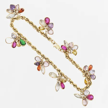 Armband, Cordell, med färgade syntetiska stenar, en sten saknas, slitna fasetter, längd ca 19cm, bredd 18mm, 18K guld, bruttovikt 12,6 gram  Vikt: 12,6 g