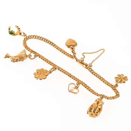 Armband, Pansar i 18K guld med 7 berlocker: Nefertiti, apa, fyrklöver. Det är 18,5 cm långt, 3 mm brett och väger 9,4g. Kistlås, säkerhetskedja. 