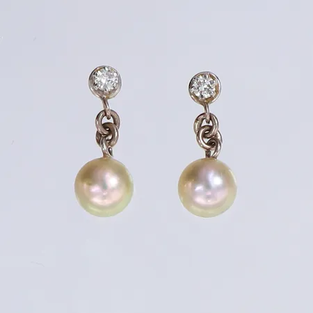 Ett par örhängen med odlade saltvattenpärlor samt briljantslipade diamanter 2 x ca0,04ct, Ø6mm, 15x6mm, pärlor med något ytslitage, vitguld 18K.  Vikt: 1,8 g