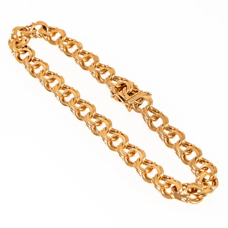 Armband bismarck i 18K guld. Det är 21,5 cm långt, 7,7 mm brett och väger 21,0g. Kistlås. 