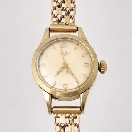 Damur Longines i 18K guld, Ø21mm, manuell, X-länk i 18K guld, totallängd inklusive ur 19cm, kronan är lös, bruttovikt 28,66g, nettovikt 20,73g.