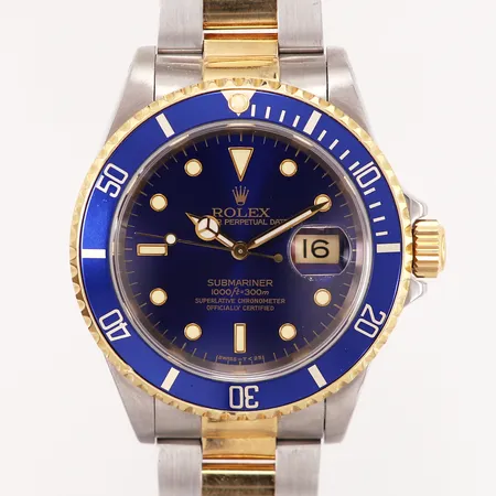 Herrur Rolex Submariner Date, Ø40mm, automatisk, guld/stål med blå urtavla, referensnummer: 16613, kaliber: 3135, serienummer: E996026, verknr: 5932301, år: 1990, Oysterlänk guld/stål, defekt viklås skruv saknas, inga tillbehör Vikt: 0 g