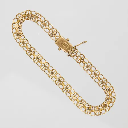 Armband, X-länk med stav, längd: 17,2cm, bredd: 5,5mm, defekt lås, en säkerhetsåtta saknas, något skev i länken, 18K  Vikt: 6,3 g