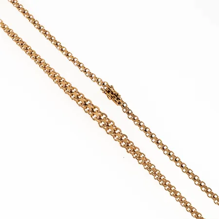 Colliér doserad X-länk i 18K guld. Det är 43,5 cm långt, 4 - 7,5 mm brett och väger 14,4g. Kistlås. 