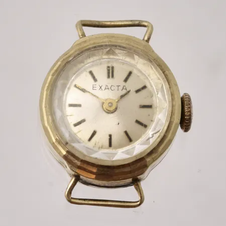 Damur Exacta i 14K guld, Ø16mm, manuell, bruttovikt 5,5g, nettovikt 1,94g.