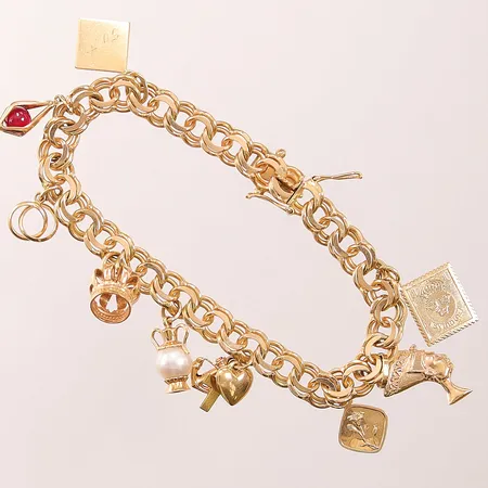 Armband, Bismarck, 19cm, bredd: 7,3mm, 9 berlocker, 18K, 28,3g.