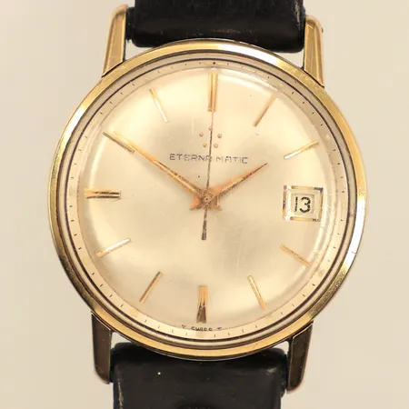 Armbandsur Eterna-Matic, guld på stål, automatisk, 34mm, boettnr 4857032, datum, repigt plexiglas, läderarmband ej original, inga tillbehör. 