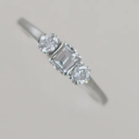 Ring med en prinsesslipad diamant på 0,30 ct + 2 st briljantslipade diamanter på 0,11 ct styck, totalt 0,52 ct, Ø 18 mm, vitguld 18k Vikt: 2 g