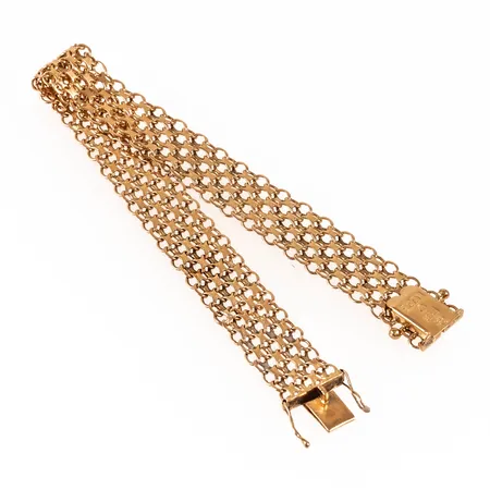 Armband x-länk i 18K guld. Det är 19,5 cm långt, 12,3 mm brett och väger 15,9g. Kistlås. Tillverkat 1964 av  Stockholms Ädelsmide. 