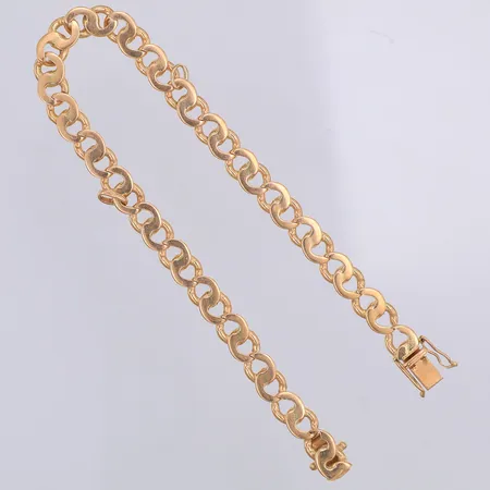 Armband, länkat, 21cm, bredd 6,5mm, ett par öglor från berlocker kvar, 18K Vikt: 23,3 g