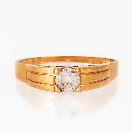Ring i 18K guld med en vit sten. Den är 1,1 - 4,3 mm bred, är i storlek 16¾ och väger 2,5g.