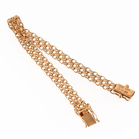 Armband x-länk i 18K guld. Det är 17 cm långt, 6,6 mm brett och väger 8,2g. Kistlås. Stämplat ESM (Svedboms Guldsmeds AB), 18K, kattfot, P9 (1965).