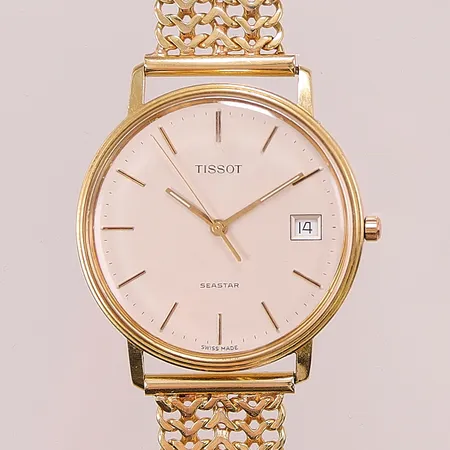Herrur Tissot Seaster 18K, 33,5mm, quartz, länk i 18K, totallängd ca 19cm, bruttovikt 48,5g.