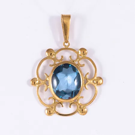 Hänge i 18K guld med en cabochonslipad ljusblå sten; från 1960. Det är 22,6 mm bred, 31,5 mm långt inkl. ögla och väger 2,9g. Stämplad 18K & kattfot. 