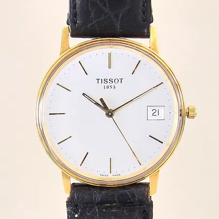 Herrur Tissot, 18K, quartz, Ø34mm, repigt glas, läderband med slitage, löst viklås, repig boett, gravyr, inga tillbehör