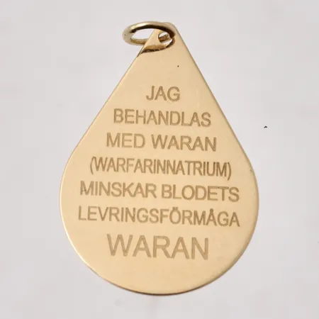 Hänge i 18K guld, Warantext, mått 20x32,3mm, vikt 2,87g.